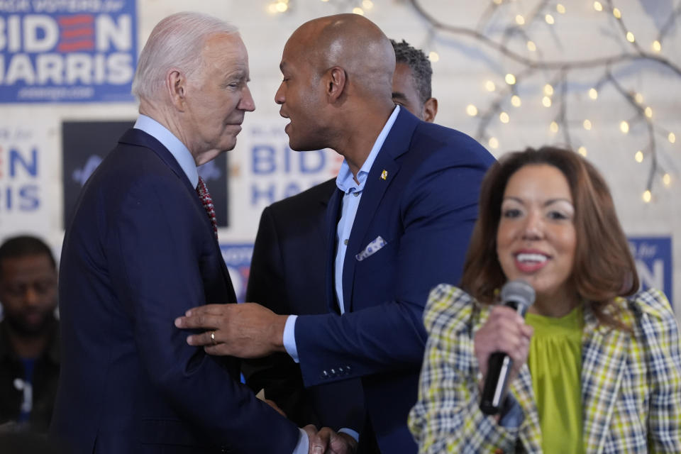 President Joe Biden talks with Maryland Gov. Wes Moore as Lynette Sutton, managing partner of Girl Concrete speaks, during a visit to SOUTH Restaurant & Jazz Club, Wednesday, May 29, 2024, in Philadelphia. (AP Photo/Evan Vucci)