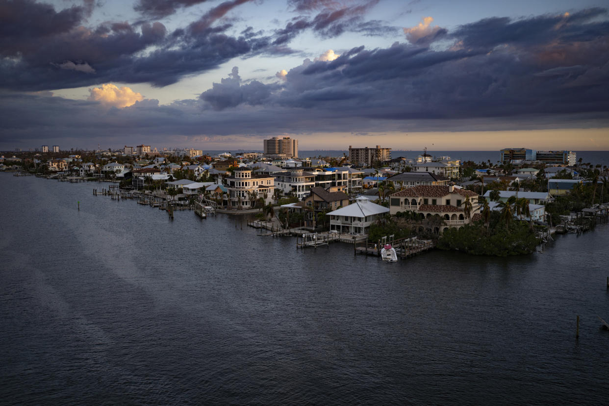A view of the Matanzas Pass side of Estero Island, home to Fort Myers Beach, which can be seen on the far side under the clouds, one month after Hurricane Ian ravaged the area. (Thomas Simonetti for NBC News)