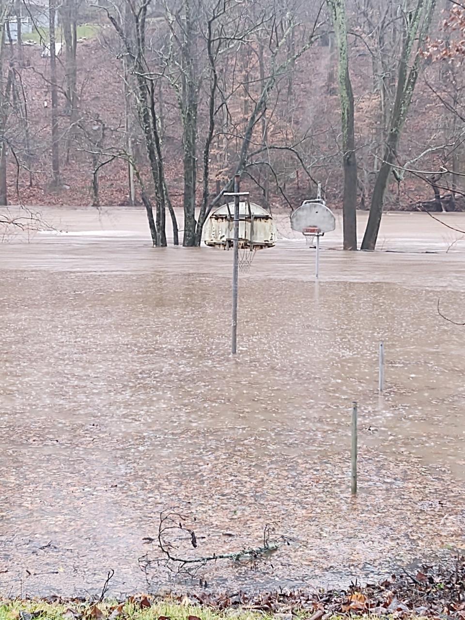 The Neshaminy Creek spills it banks near Periwinkle Park in Middletown and impacts parts of Neshaminy Woods in Lower Southampton. Some streets in the community were under water Monday afternoon.