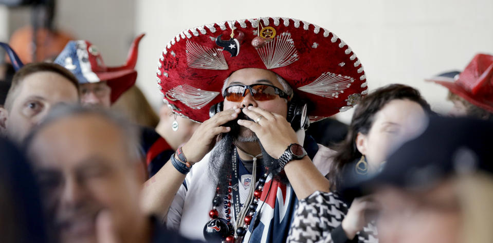Houston Texans fan Frank Carrera adjusts his mustache as he waits for the start of the NFL draft at a Houston Texans draft day party at NRG Stadium Thursday, May 8, 2014, in Houston. The Texans have the number one pick in the NFL draft. (AP Photo/David J. Phillip)