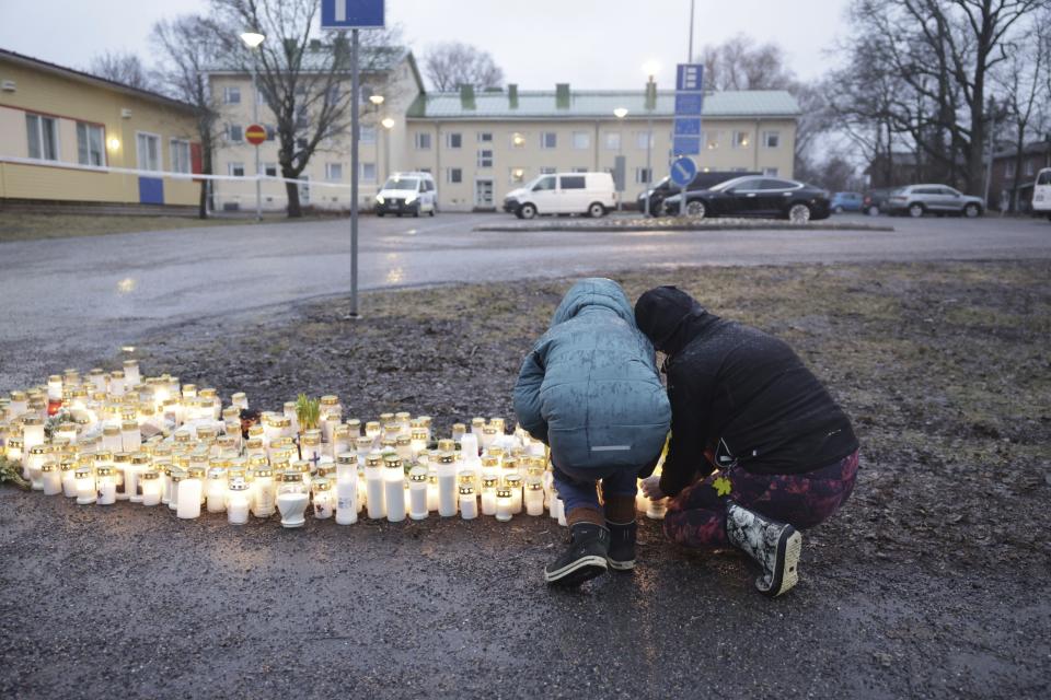 People bring candles and flowers at the Viertola school in Vantaa, Finland, Tuesday April 2, 2024, after a shooting incident. A 12-year-old student opened fire at a secondary school in southern Finland on Tuesday morning, killing one and seriously wounded two other students, police said. The suspect was later arrested. (Roni Rekomaa/Lehtikuva via AP)