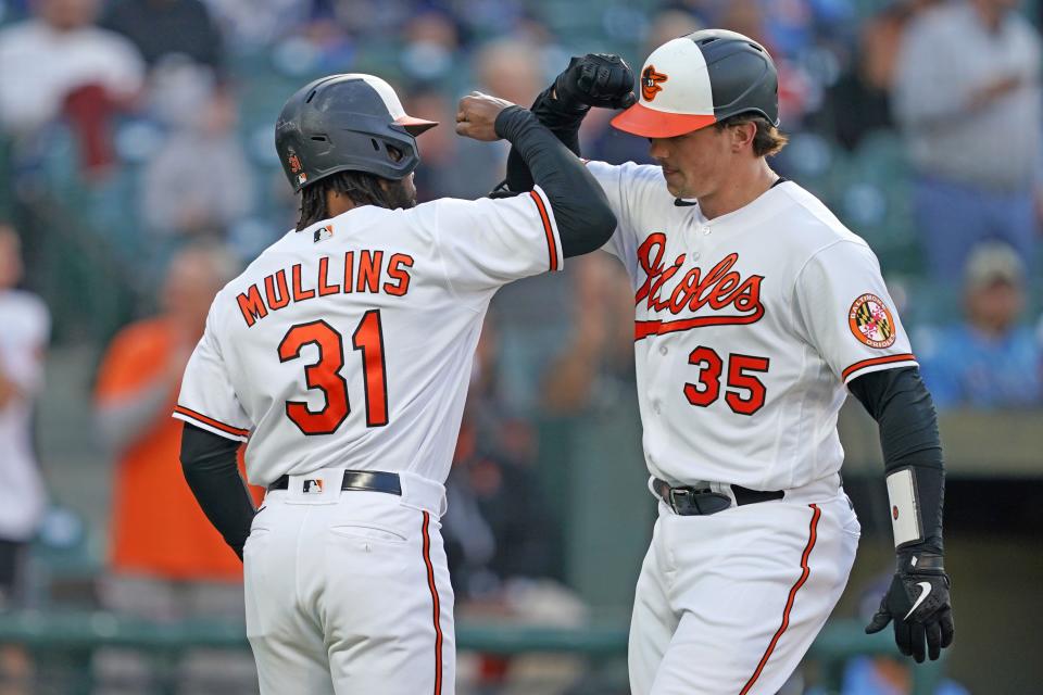 Orioles catcher Adley Rutschman is greeted by outfielder Cedric Mullins after a homer against the Rays.
