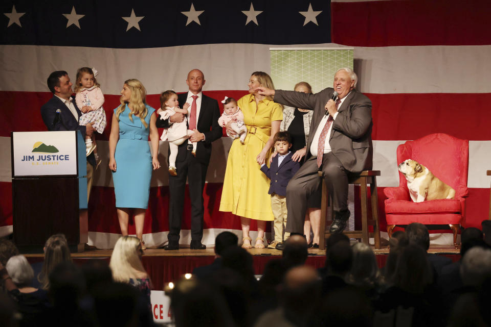 Gov. Jim Justice speaks with his family on stage during an announcement for his campaign for U.S. Senate at The Greenbrier Resort in White Sulphur Springs, W.Va., on Thursday, April 27, 2023. (AP Photo/Chris Jackson)