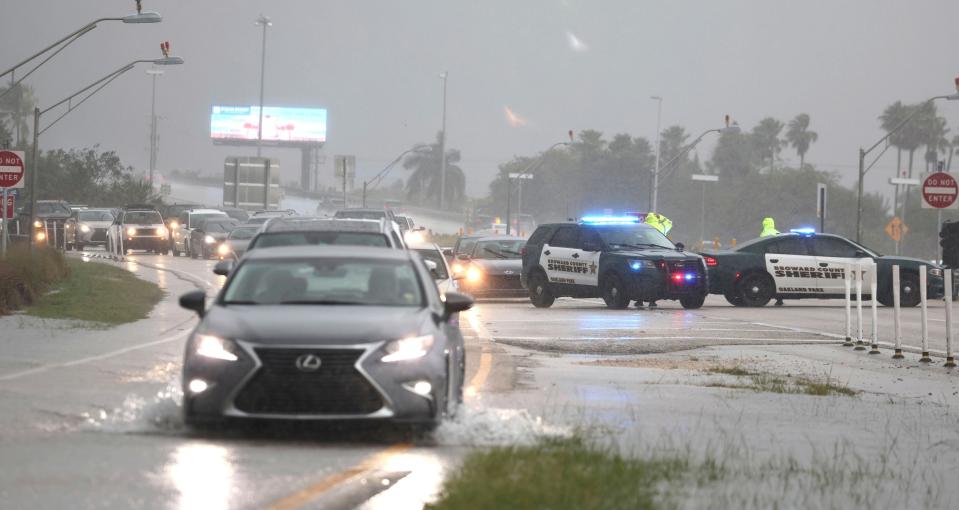 Broward Sheriff's Office deputies direct traffic away from the Fort Lauderdale-Hollywood International Airport, which has closed to all flights and traffic on Wednesday, April 12, 2023, in Fort Lauderdale, Fla. (Carline Jean/South Florida Sun-Sentinel via AP)