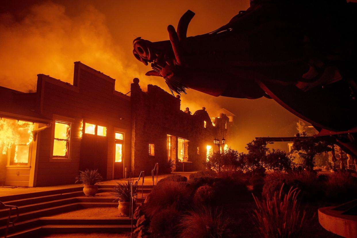 In this Oct. 27, 2019, photo, flames from the Kincade Fire consume Soda Rock Winery in Healdsburg, Calif.