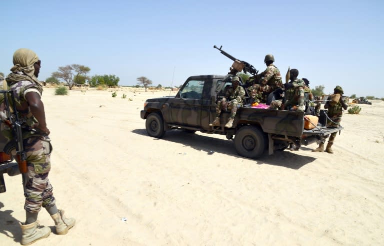 Niger soldiers ride in a military vehicle on May 25, 2015 in Malam Fatori, near the border with Niger, where Niger and Chadian army troops are working together to fight Boko Haram