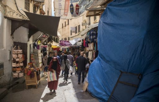 Tourists and locals walk in the medina in Fez, listed as a UNESCO World Heritage Site in 1981 for its "outstanding universal value"