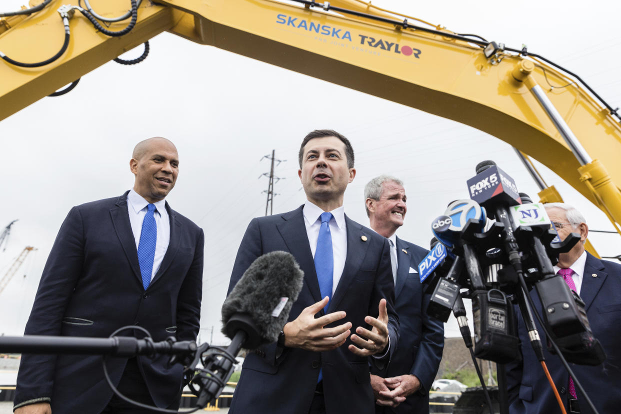 FILE - Sen. Cory Booker, D-N.J., Transportation Secretary Pete Buttigieg and N.J. Gov. Phil Murphy speak to the media after at a groundbreaking ceremony for the New Portal North Bridge project held in Kearny, N.J., Aug. 1, 2022. NJ Transit and Amtrak are replacing the century-old Portal Bridge over the Hackensack River in New Jersey doubling rail capacity between Newark and New York. (AP Photo/Stefan Jeremiah, File)