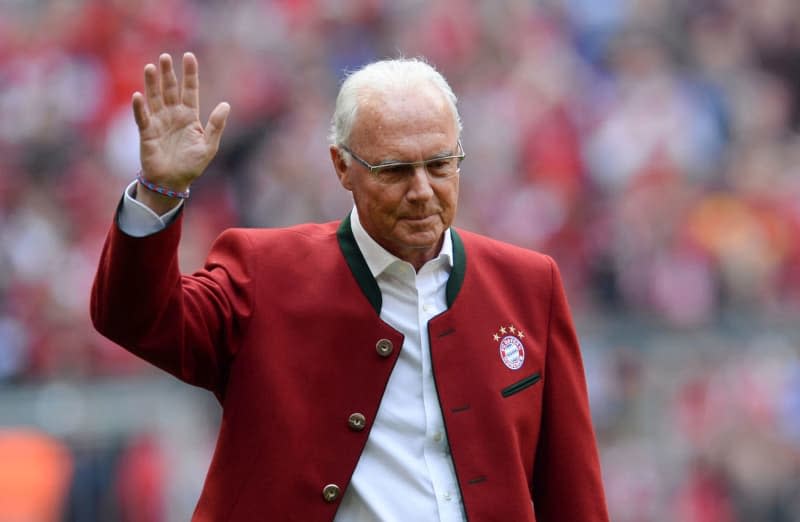 Bayern Munich honorary President Franz Beckenbauer walks to the podium during the presentation of the champion teams ahead of the start of the German Bundesliga soccer match between Bayern Munich and Hannover 96 at the Allianz Arena. Beckenbauer, considered the greatest German football legend, died on Sunday at the age of 78, his family told dpa on Monday. Andreas Gebert/dpa