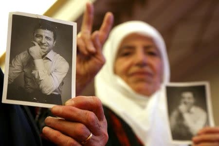 Supporters of the pro-Kurdish Peoples' Democratic Party (HDP) hold pictures of Selahattin Demirtas, the party's jailed former co-leader and the candidate for the upcoming presidential election, during a gathering in Diyarbakir, Turkey May 4, 2018. REUTERS/Sertac Kayar