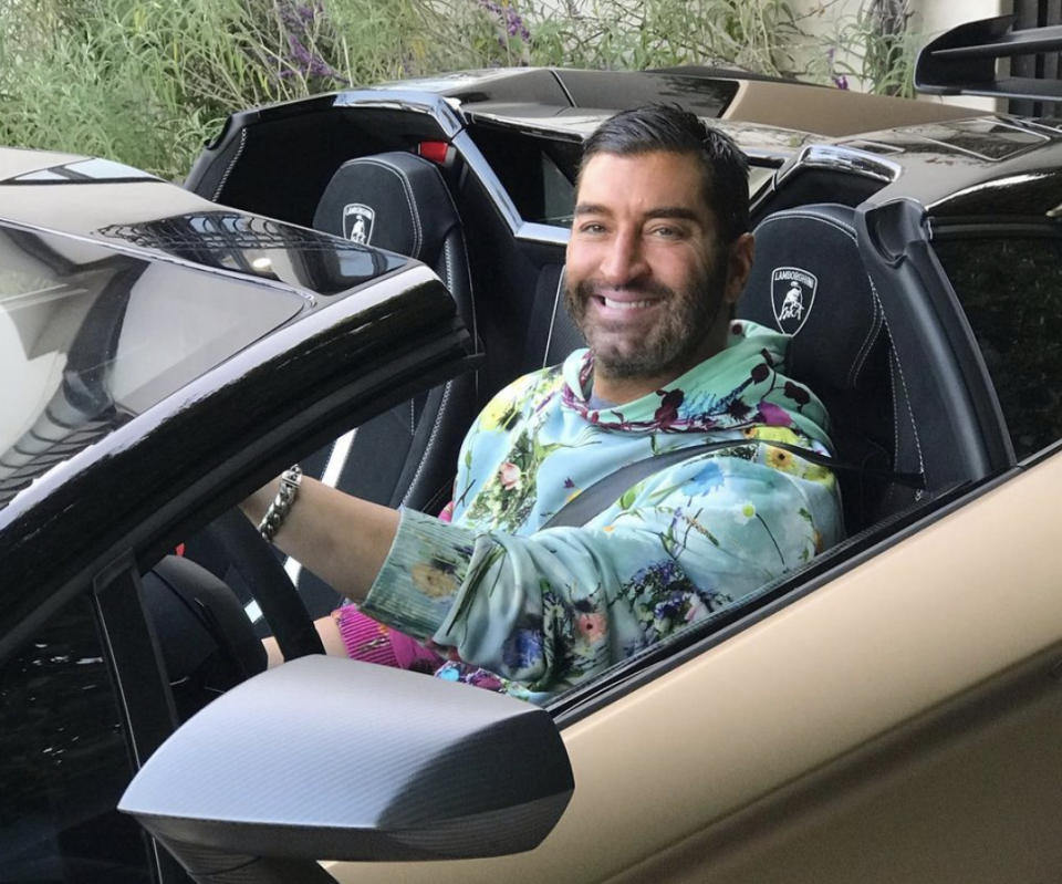 James Khuri is pictured behind the wheel of a Lamborghini.