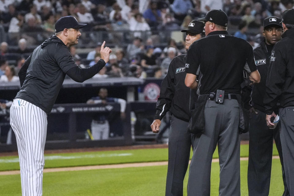 New York Yankees manager Aaron Boone, left, argues with umpires during the eighth inning of the team's baseball game against the Tampa Bay Rays, Wednesday, June 15, 2022, in New York. (AP Photo/Bebeto Matthews)