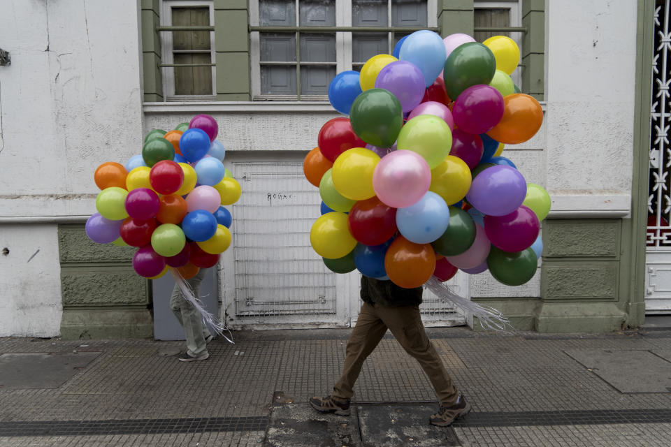 Protesters carry balloons to a march on International Workers' Day in Santiago, Chile, Wednesday, May 1, 2024. (AP Photo/Matias Basualdo)