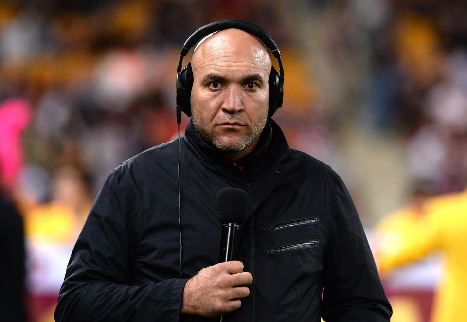 Seen here, Broncos legend Gordon Tallis performing commentary duties at an NRL game.