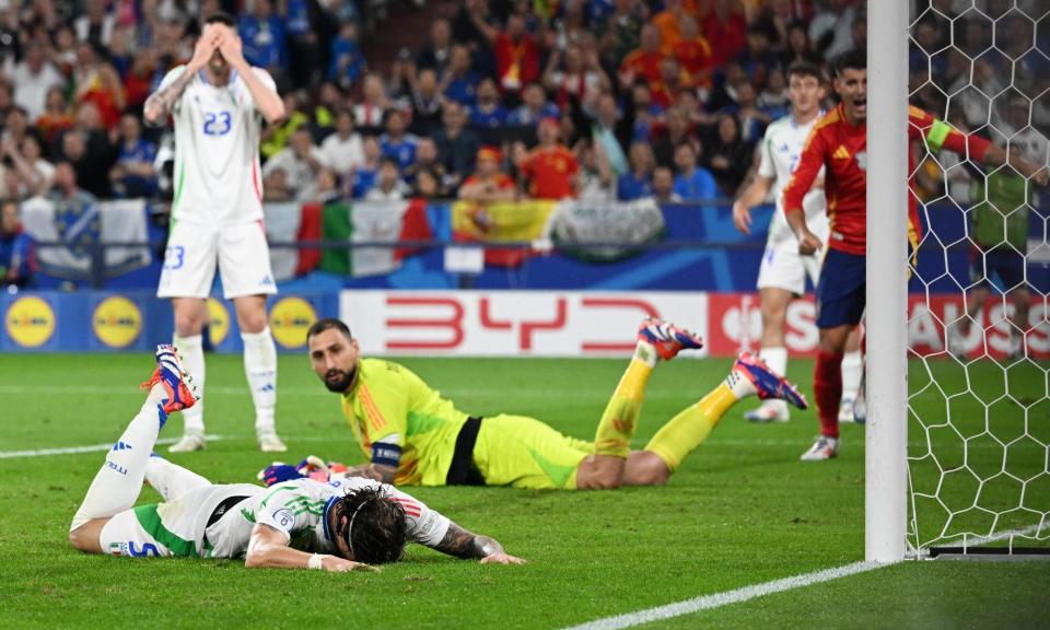 <span>Riccardo Calafiori buries his head in the pitch after his own goal puts <a class="link " href="https://sports.yahoo.com/soccer/teams/spain-women/" data-i13n="sec:content-canvas;subsec:anchor_text;elm:context_link" data-ylk="slk:Spain;sec:content-canvas;subsec:anchor_text;elm:context_link;itc:0">Spain</a> in the lead.</span><span>Photograph: Carmen Jaspersen/Reuters</span>