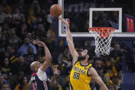 Indiana Pacers center Goga Bitadze (88) blocks a shot by Washington Wizards forward Taj Gibson (67) during the first half of an NBA basketball game, Friday, Dec. 9, 2022, in Indianapolis. (AP Photo/Darron Cummings)