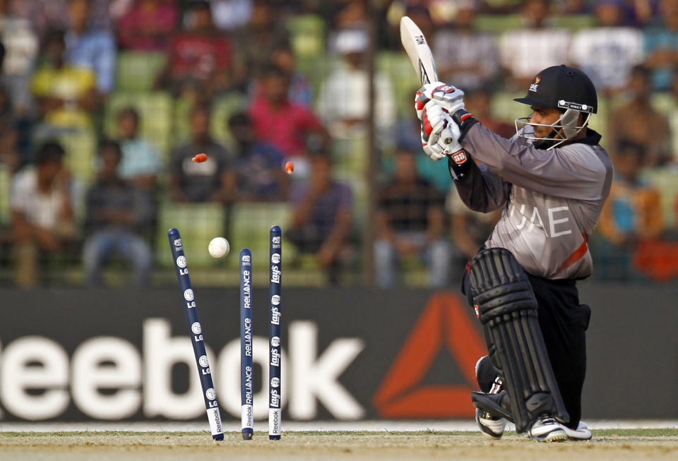 The bails fly off the wickets resulting in the dismissal of United Arab Emirates' Khurram Khan during a warm-up cricket match against Bangladesh ahead of the Twenty20 World Cup Cricket in Fatullah, near Dhaka, Bangladesh, Wednesday, March 12, 2014. (AP Photo/A.M. Ahad)