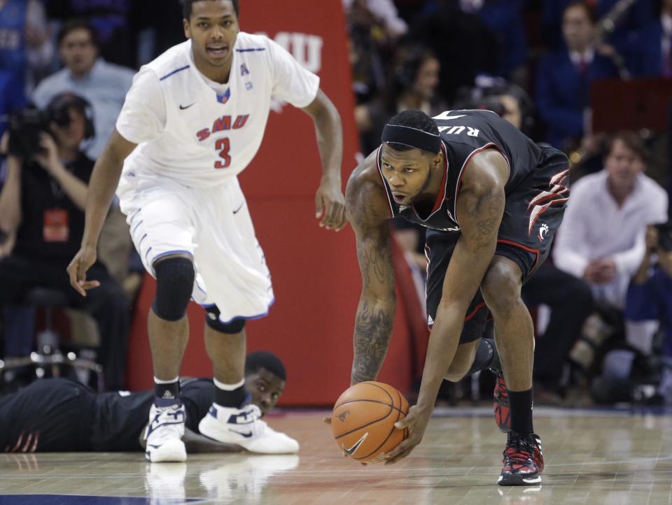 Cincinnati forward Titus Rubles picks up a loose ball in front of SMU guard Sterling Brown (3) during the first half of an NCAA college basketball game Saturday, Feb. 8, 2014, in Dallas. (AP Photo/LM Otero)