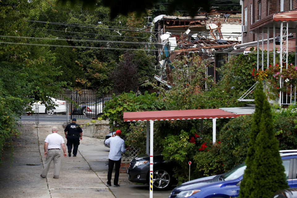 <p>People stand in an alley near a home that was destroyed by an explosion in the early morning in the Bronx borough of New York on Sept. 27, 2016. (Carlo Allegri/Reuters) </p>