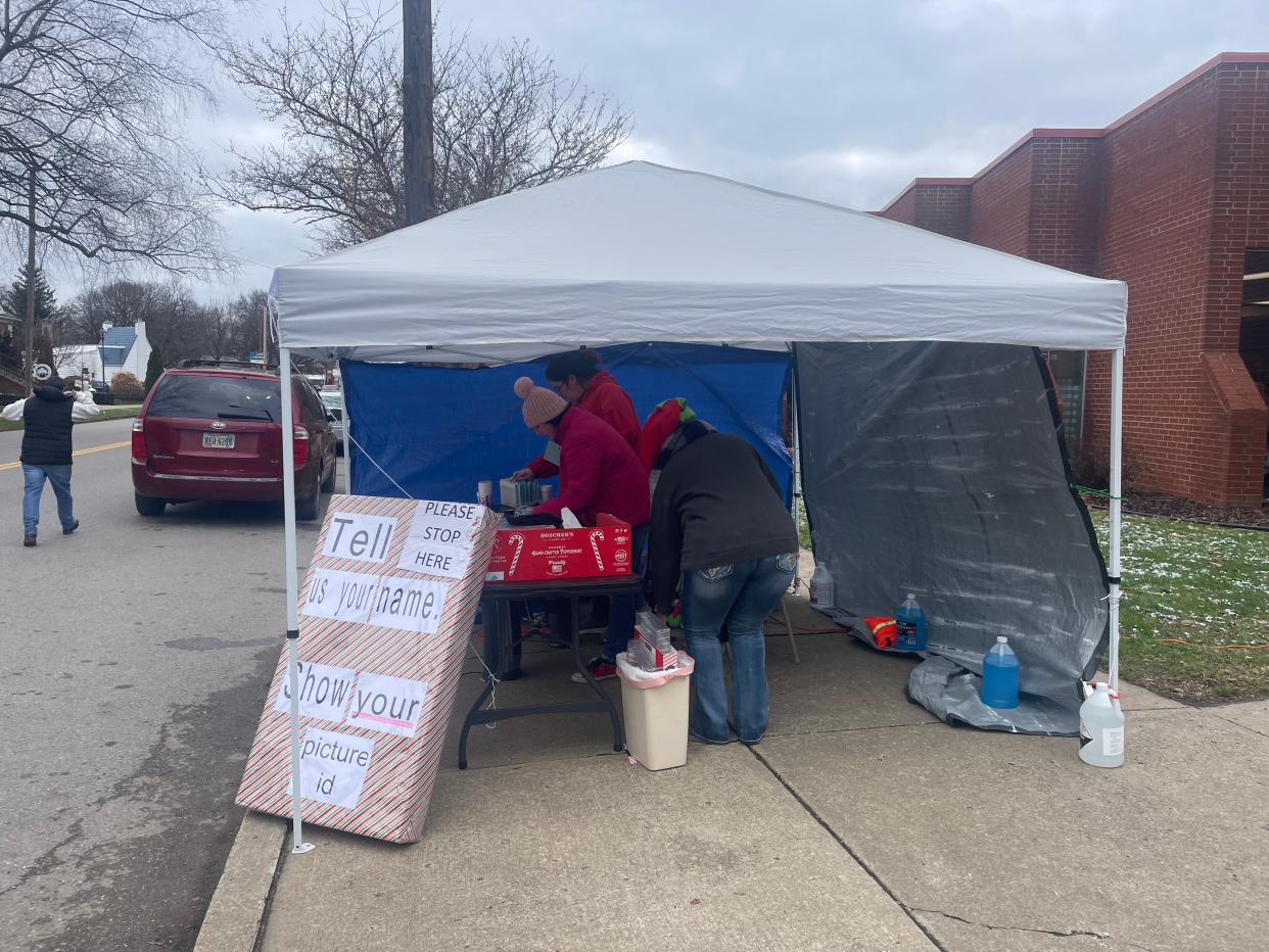 Cars lined up at the front of the Salvation Army on Putnam Avenue. Boxes of toys and food were distributed in the back of the building.