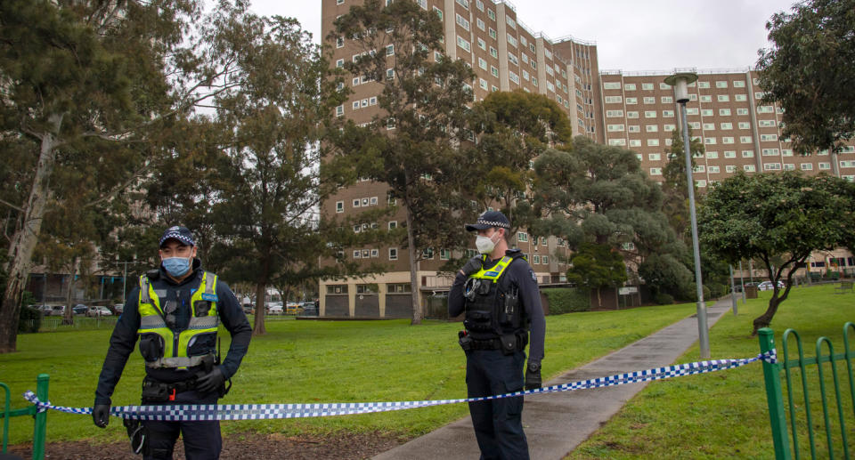 Photo of police outside a public housing tower in Melbourne.