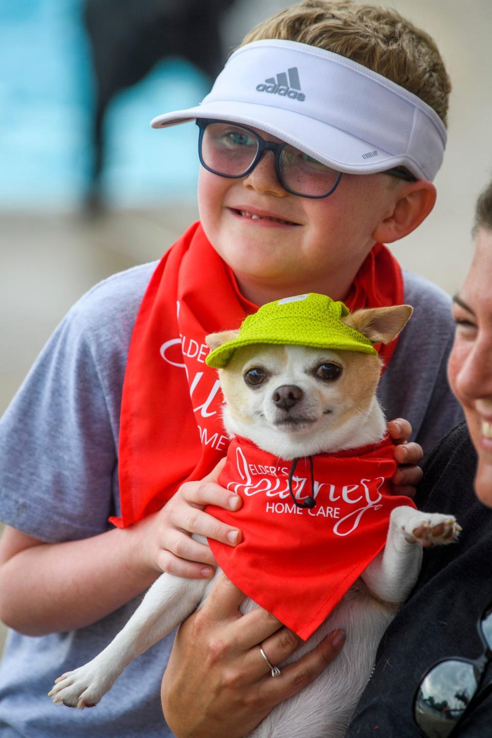 Second place winner in the dog and owner look-a-like contest Silas Hendrickson and Chip pose for the judges during Drool in the Pool at Mills Pool on Thursday, Aug. 4, 2022.