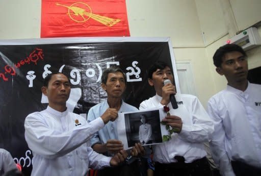 Myanmar's Generation '88 student leaders Ko Ko Gyi (L) and Min Ko Naing (2nd R) hold a picture of student Phyo Phyo Aung (C) speak to the media at the Generation '88 office in Yangon. Authorities have freed all of the student leaders detained in the country's biggest crackdown on activists since the dissolution of the junta