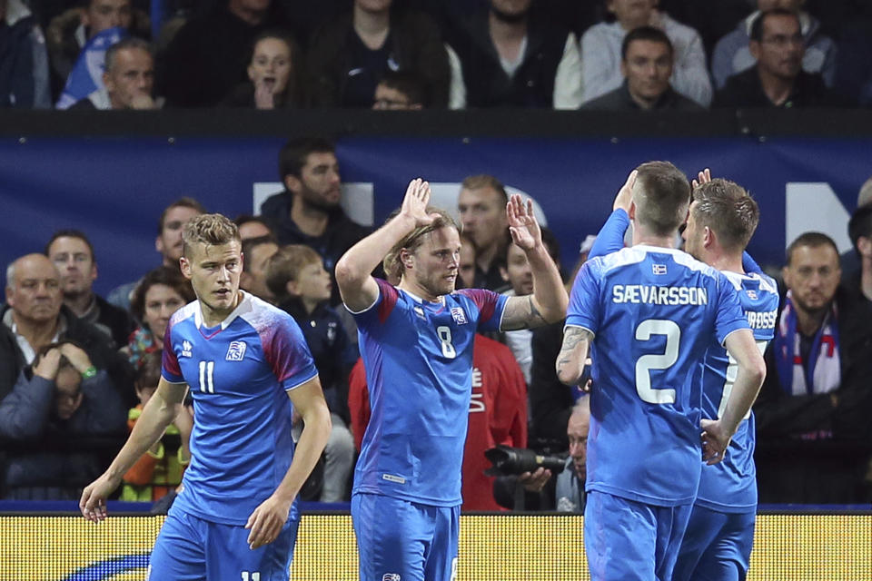 Iceland's Birkir Bjarnason, second from left, celebrates with teammate after scoring a goal during a friendly soccer match between France and Iceland, in Guingamp, western France, Thursday, Oct. 11, 2018. (AP Photo/David Vincent)