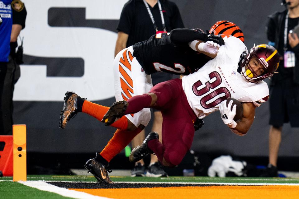 Washington Commanders running back Austin Ekeler scores a touchdown against the Cincinnati Bengals