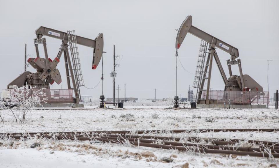 Pump jacks operate in the snow in Midland, Texas, in February.