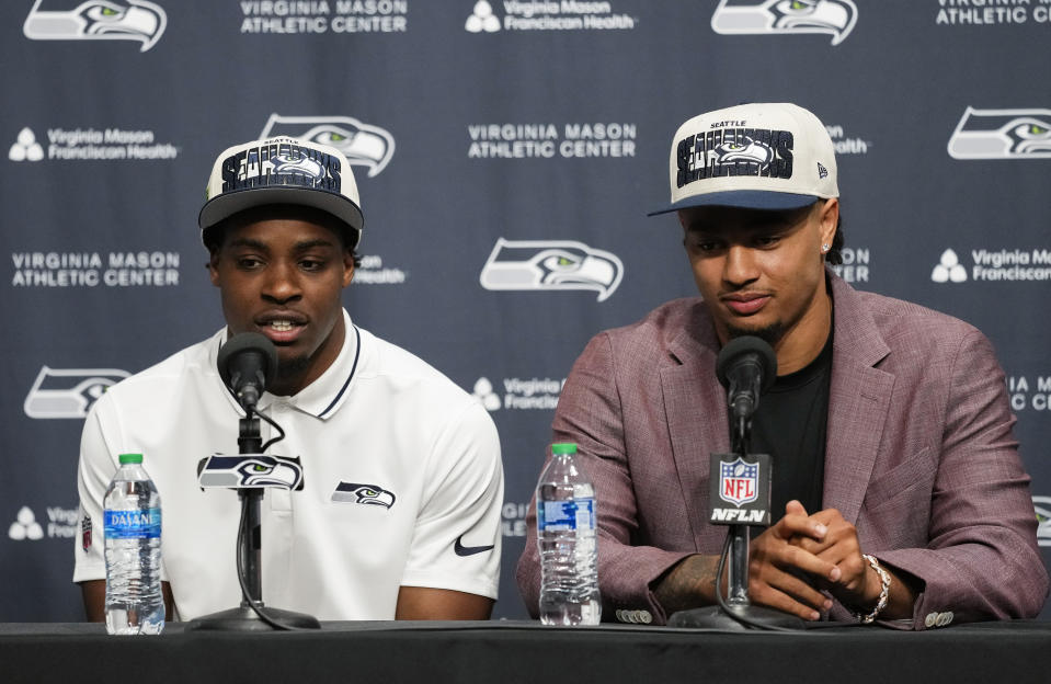 Seattle Seahawks first-round NFL football draft picks Devon Witherspoon, a cornerback from Illinois, at left, and Jaxon Smith-Njigba, a wide receiver from Ohio, speak during a news conference, Friday, April 28, 2023, at the team's headquarters in Renton, Wash. (AP Photo/Lindsey Wasson)