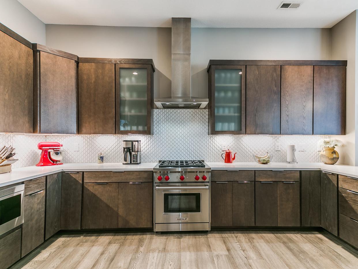 The expanded chef's kitchen features Wolf appliances and a walk-in pantry.