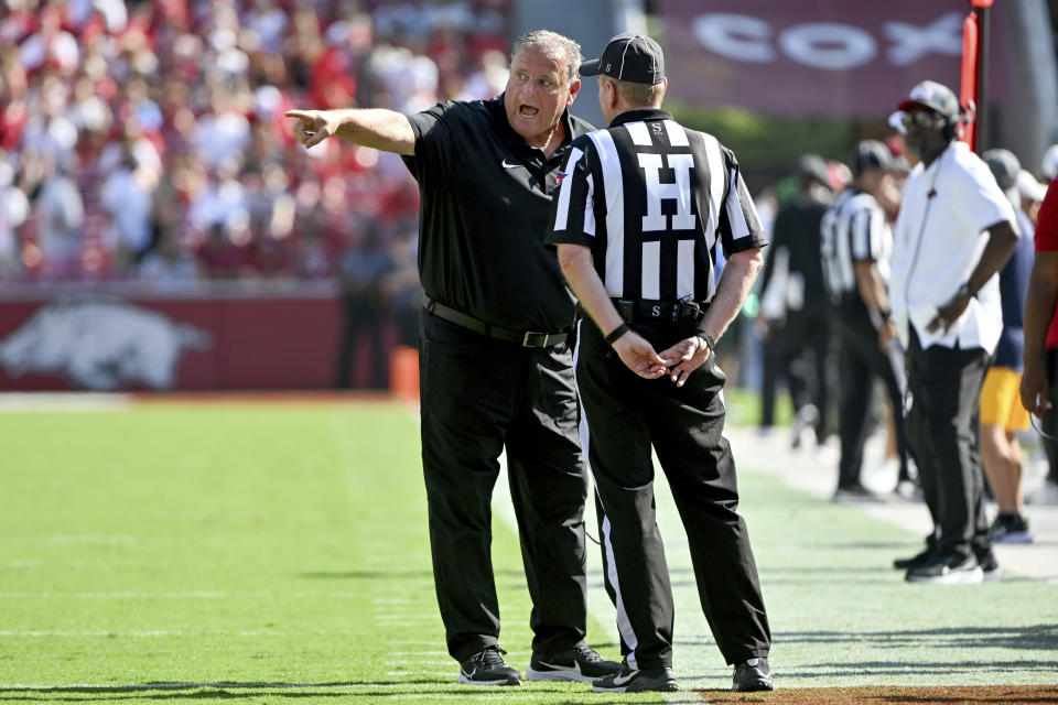 Arkansas coach Sam Pittman has a word with an official on the sideline during the first half of an NCAA college football game against Kent State on Saturday, Sept. 9, 2023, in Fayetteville, Ark. (AP Photo/Michael Woods)