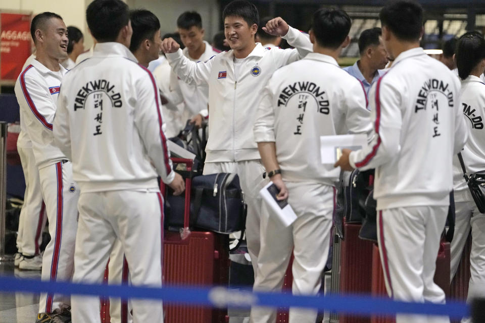 North Koreans wearing track suits with the North Korean flag and the words Taekwon-Do printed on the back line up to check in for a flight to Astana at the Capital Airport in Beijing, Friday, Aug. 18, 2023. A team of North Korean Taekwondo athletes are reportedly travelling via China to Astana, capital of Kazakhstan, to compete in a Taekwondo competition. (AP Photo/Ng Han Guan)