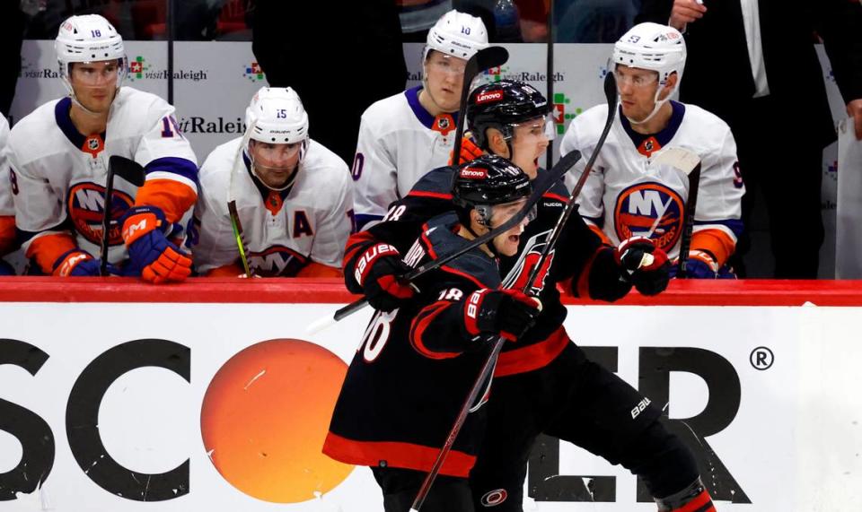 Carolina’s Martin Necas and Jack Drury celebrate after Necas scored an empty-net goal during the third period of the Hurricanes’ 3-1 victory over the Islanders in the first round of the Stanley Cup playoffs on Saturday at PNC Arena in Raleigh, N.C.