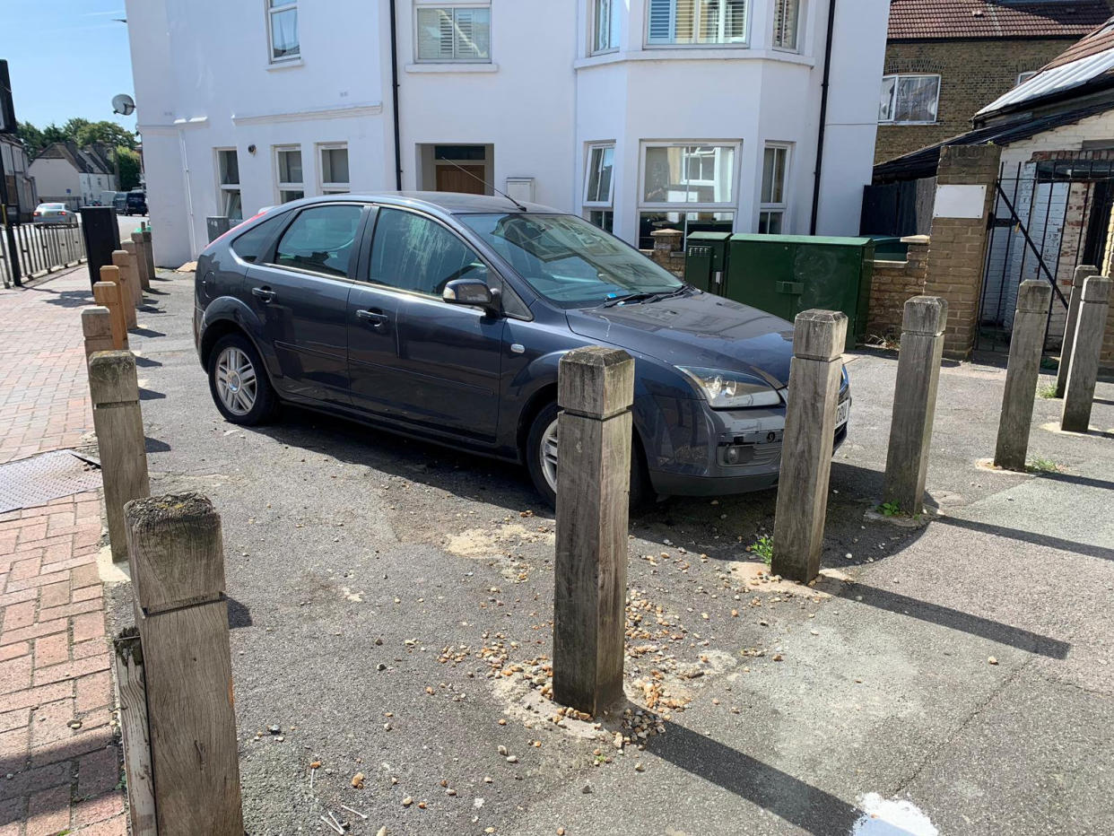 Blocked in - the car after being sandwiched in by three bollards (SWNS)