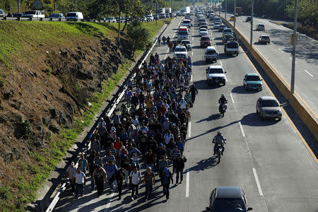 Salvadorans take part in a new caravan of migrants, set to head to the United States, as they leave San Salvador, El Salvador January 16, 2019. REUTERS/Jose Cabezas