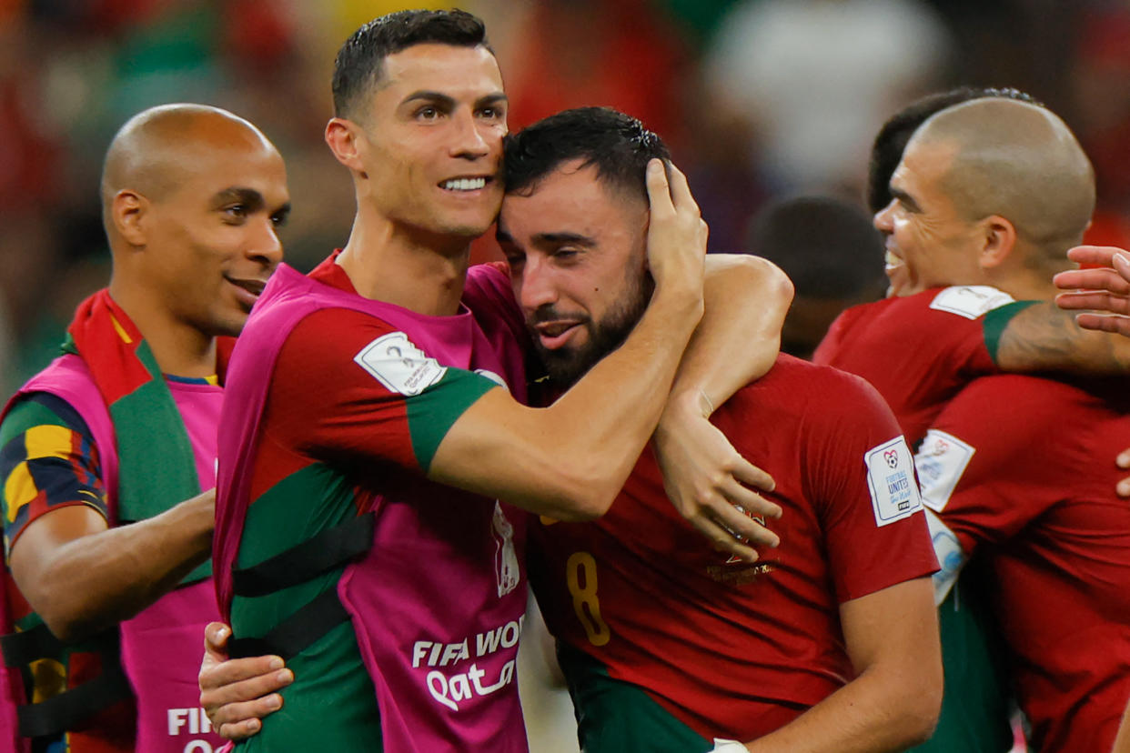 Portugal's Cristiano Ronaldo (L) and Portugal's midfielder #08 Bruno Fernandes celebrate after they won the a 2022 World Cup Group H match against Uruguay. (ODD ANDERSEN/AFP via Getty Images)