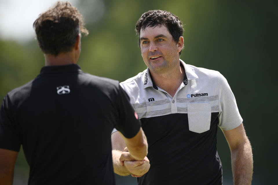 Keegan Bradley, right, shakes the hand of Adam Scott, of Australia, left, after they finished their round on the 18th green during the first round of the BMW Championship golf tournament at Wilmington Country Club, Thursday, Aug. 18, 2022, in Wilmington, Del. (AP Photo/Nick Wass)