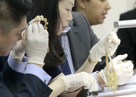 Members of Christie's appraise jewelry of former first lady Imelda Marcos during the Presidential Commission on Good Government (PCGG) appraisal of the confiscated jewelry collection from the Marcos family inside the Central Bank headquarter in Manila November 24, 2015. REUTERS/Romeo Ranoco