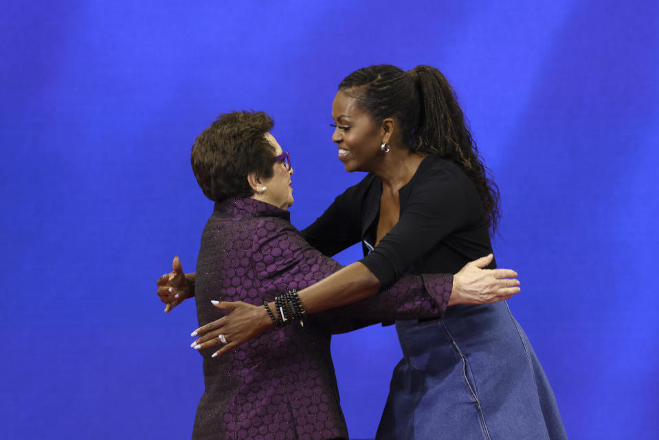 Former first lady Michelle Obama, right, and tennis legend Billie Jean King, embrace during the opening ceremony of the of the U.S. Open tennis championships, Monday, Aug. 28, 2023, in New York. (AP Photo/Jason DeCrow)