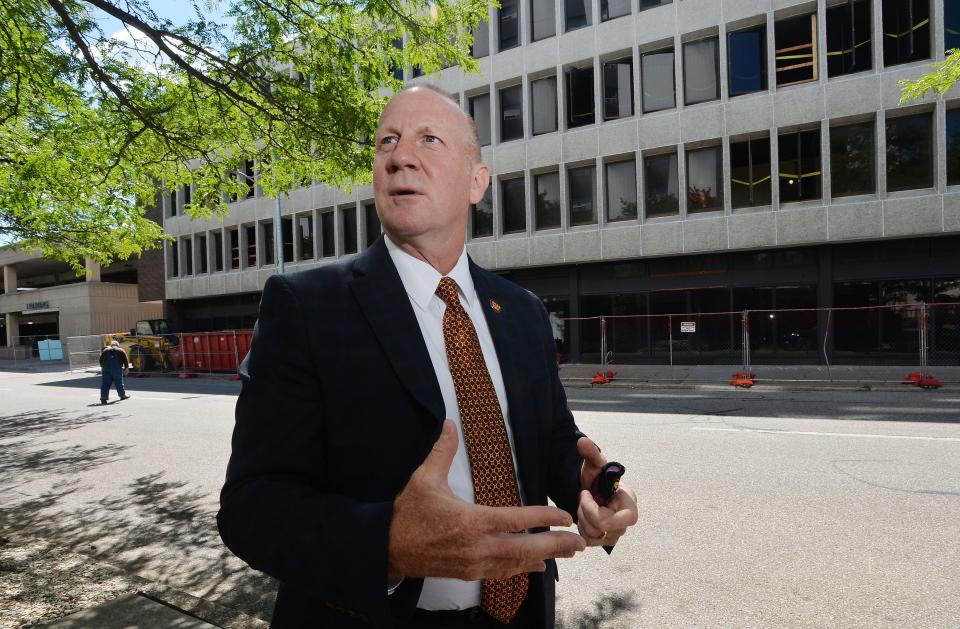 Keith Taylor, president of Gannon University, describes construction of South Hall, background, on June 23, 2021, in Erie. Taylor said the building, once used for offices and governmental agencies, will be renovated into a residence hall.