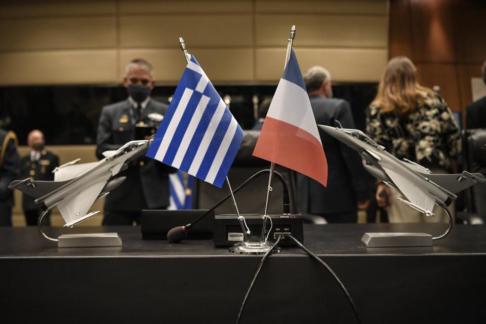 Models of Rafale jets are displayed next to Greek and French flags prior to French Defense Minister Florence and her Greek counterpart Nikos Panagiotopoulos signing the warplane deal in Athens, Monday, Jan. 25, 2021. Greece is due to sign a 2.3 billion euro ($2.8 billion) deal with France Monday to purchase 18 Rafale fighter jets to address tension with neighbor Turkey. (Louisa Gouliamaki/Pool via AP)