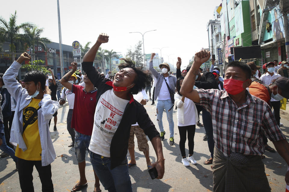 Protesters shout slogans during a protest against the military coup in Mandalay, Myanmar, Sunday, Feb. 28, 2021. Police fired tear gas and water cannons and there were reports of gunfire Sunday in Myanmar's largest city Yangon where another anti-coup protest was underway with scores of students and other demonstrators hauled away in police trucks. (AP Photo)