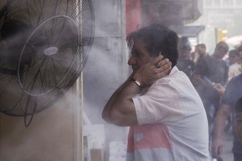 A man cools off during a heat wave in Baghdad on July, 6, 2023.  (Hadi Mizban / AP file)