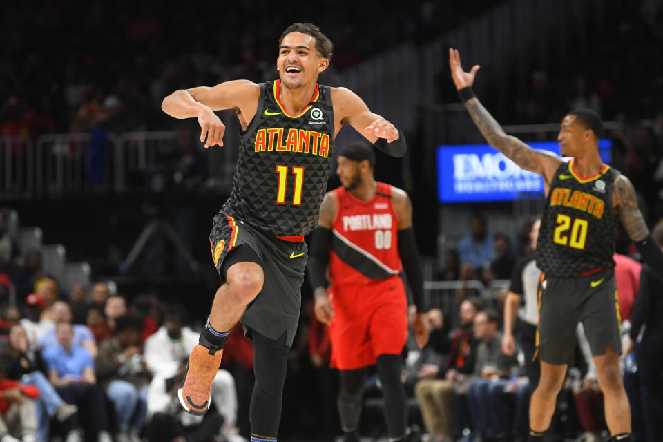 Atlanta Hawks guard Trae Young (11) reacts after a long range assist during the second half of an NBA basketball game against thePortland Trail Blazers, Saturday, Feb. 29, 2020, in Atlanta. The Hawks won 129-117. (AP Photo/John Amis)