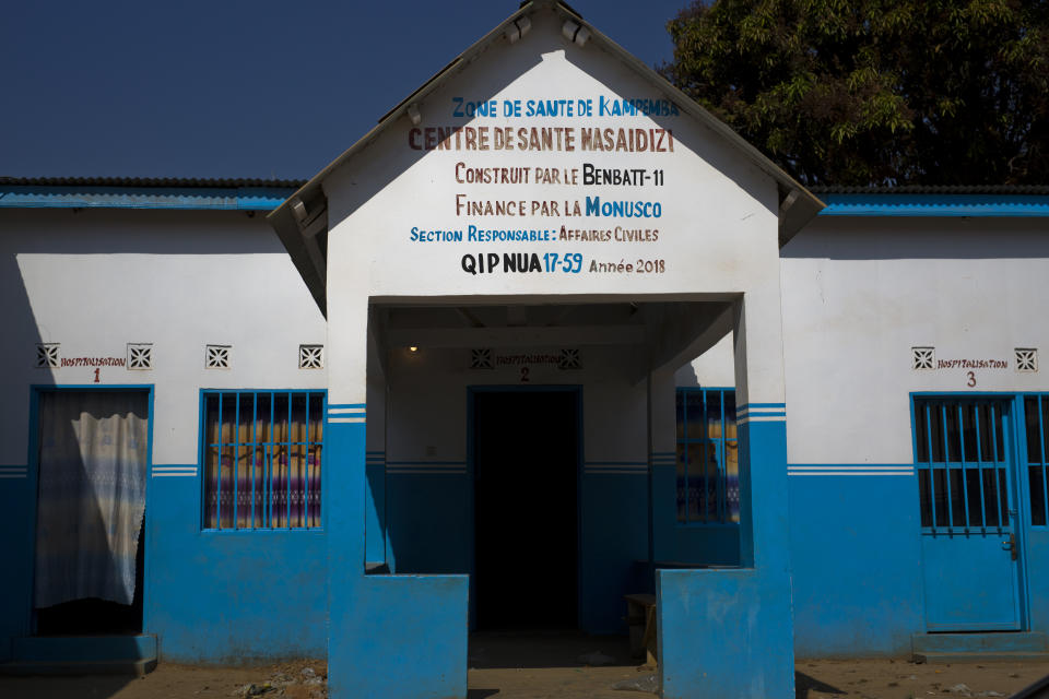 This Tuesday, Aug. 14, 2018 photo shows the entrance of the Masaidizi Health Center, which was recently built by the United Nations in Lubumbashi, Democratic Republic of the Congo. The health compound's four buildings are painted in white and U.N. blue, although the hospital is now run by the Congolese ministry of health and receives no ongoing U.N. support. (AP Photo/Jerome Delay)