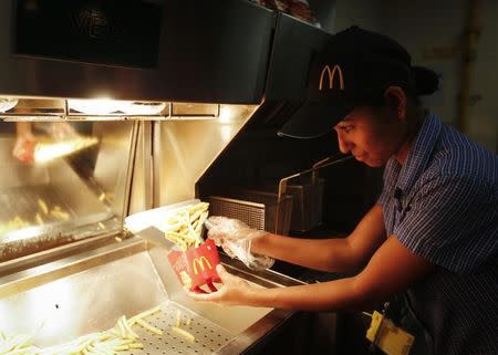 A staff member prepares French fries at a McDonald's restaurant in Mumbai February 10, 2015. REUTERS/Shailesh Andrade/Files