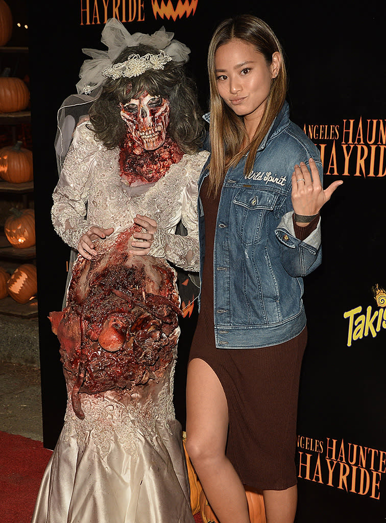 <p>Over at the Los Angeles Haunted Hayride, <i>Once Upon a Time</i> actress Jamie Chung didn’t seem grossed out at all by this scary zombie bride. (Photo: Splash News) </p>