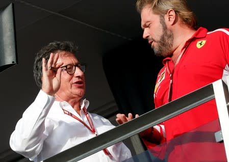 New Ferrari's CEO Louis Carey Camilleri speaks with a technician after the Italian Formula One Grand Prix at the Monza racetrack